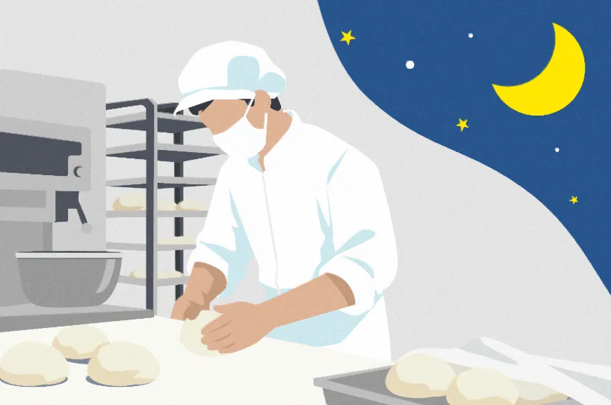 夜間にキッチンでパン作りをするパン職人の男性のイラスト